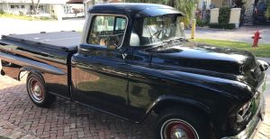 old black truck in a driveway