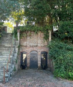 Photograph of a semi-underground access tucked next to a staircase.