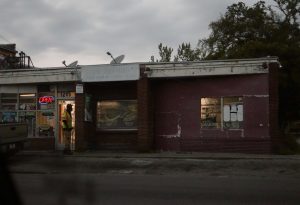 Photo of one-story building housing a convenience store.