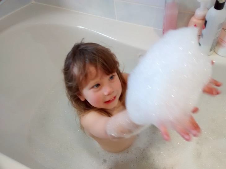 A child in a bathtub.